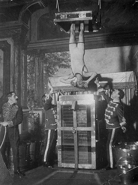 Houdini performing water torture cell